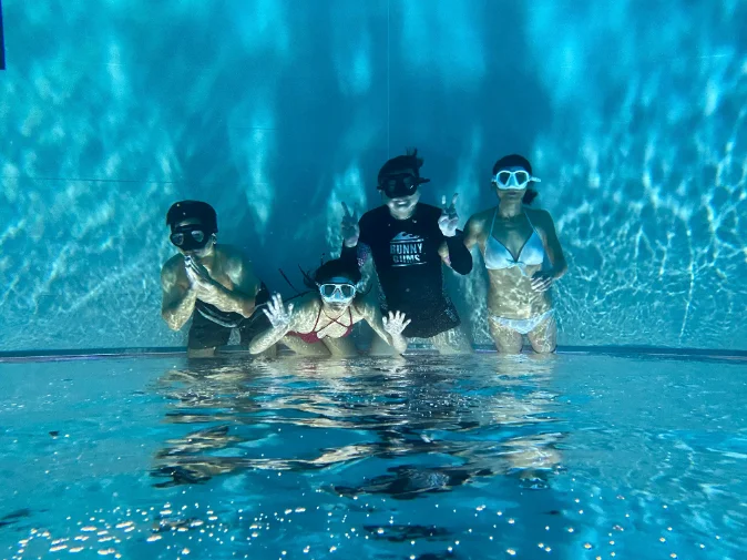 Family swimming together in the pool